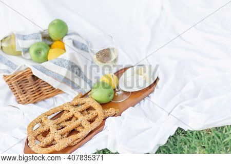 Breakfast At Sunrise, On The Grass White Sheet With A Tray With Cheese And Vine, Dry Bread, Apple, L