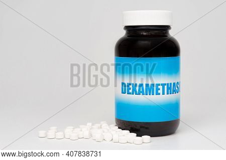 Dexamethasone Glass Bottle Packaging With Scattered Pills. Treatments For Covid-19. Isolated On Whit