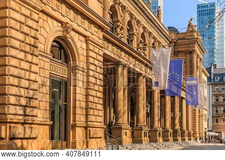 Historic Building Of The Stock Exchange In Frankfurt With Flags Above The Entrance. Brown Colored Co