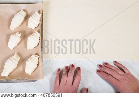 Woman Hands Making Croissants From Puff Pastry And Big Lay Of Puff Pastry, With Copy Space.