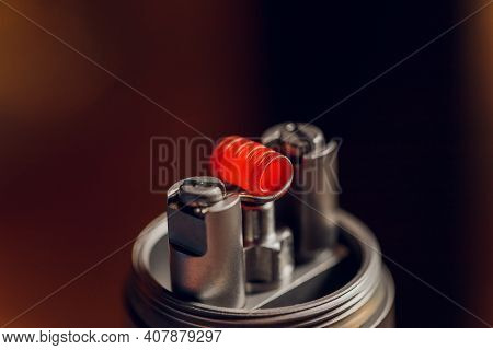 Vaping Device With A Hot Spring On A Black Background For Evaporation.