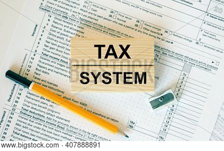 Wooden Blocks With Text Tax System On Financial Docs