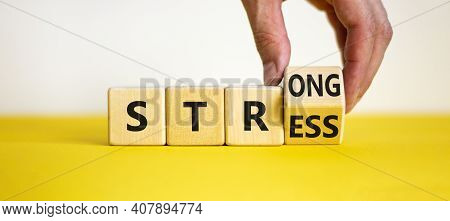 Strong Stress Symbol. Businessman Turns Wooden Cubes With Words 'strong Stress'. Beautiful Yellow Ta