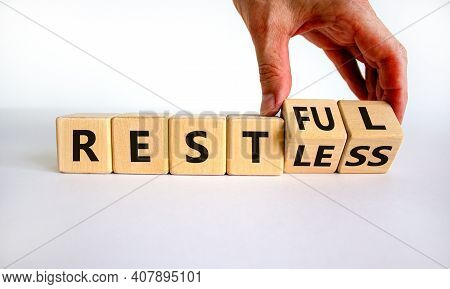 Restless Or Restful Symbol. Businessman Turns Wooden Cubes, Changes The Word 'restless' To 'restful'