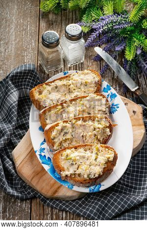 Sandwiches With A Paste Of Mackerel, Egg And Cucumber On A Wooden Table.