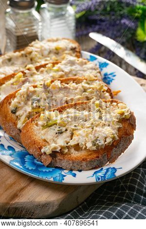 Sandwiches With A Paste Of Mackerel, Egg And Cucumber On A Wooden Table.