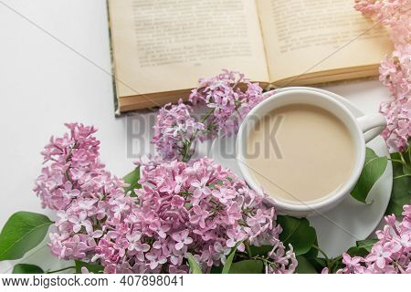 Spring Cozy Composition Flat Lay Coffee Cup, Book, Lilac Branches, Spring Season Concept