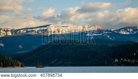 Mountains In The Snow, Overgrown With Wood. Thick Clouds Over The Mountains.