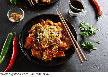 Spicy Garlic Fried Chicken (kkanpunggi). Asian Chicken In Sweet And Sour Sauce On Plate Over Black S