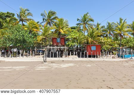 Panama Armuelles, House On Stilts Among The Palm Trees Of The Beach On A Sunny Day