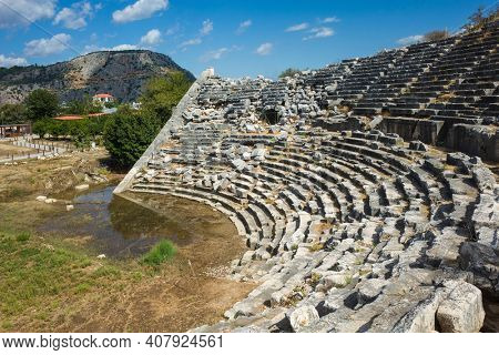 Ruins of Theatre in Letoon Ancient City in village Kumluova, Turkey. Sunny day, Greek culture ancient amphitheater architecture
