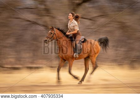 Slow Pan Of Brunette Riding In Woods