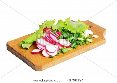 Frisk Slised radise, løg og salat på Skærebrættet isoleret på hvid