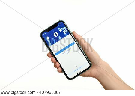 Mykolaiv, Ukraine - July 9, 2020: Woman Holding  Iphone X With Facebook App On White Background, Clo