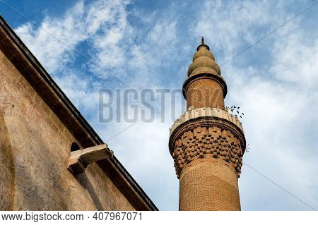 Close Up Of Bursa Grand Mosque Minaret With Blue Sky.