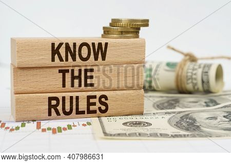 Business And Finance Concept. On The Table Are Dollars, Financial Charts And Wooden Plates On Which 