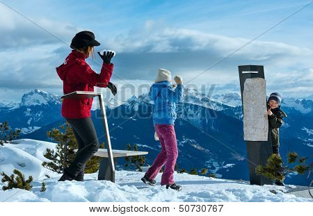 Family Plays At Snowballs On Winter Mountain Slope