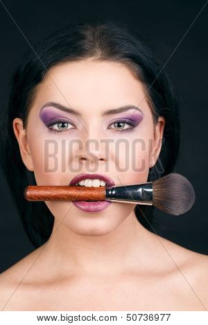 Portrait beautiful white hair girl with makeup brushes near the face