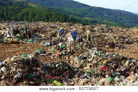 People pick up garbage at landfill