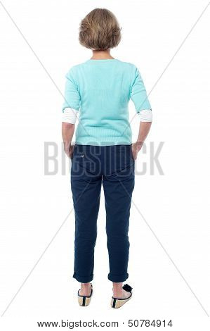 Back Pose Of An Old Lady Facing The Wall