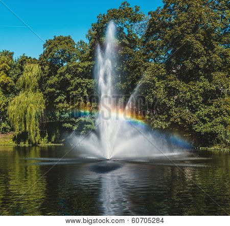 Fountain  And Rainbow In Riga Canal, That Flows Through Bastion Park (bastejkalns). Latvia