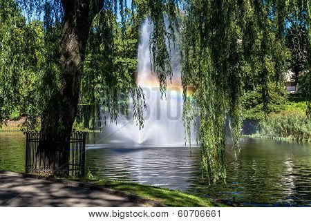 Fountain  And Rainbow In Riga Canal, That Flows Through Bastion Park (bastejkalns). Latvia