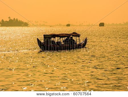 Sunset Silhouette Scene Of A Boat From The Backwaters Of Kerala, India.