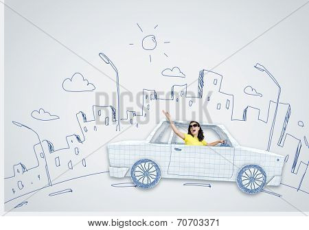 Young woman riding car made of list of paper