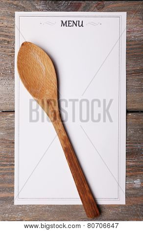 Menu sheet of paper on rustic wooden surface background