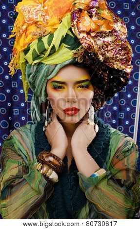 beauty bright woman with creative make up, many shawls on head l