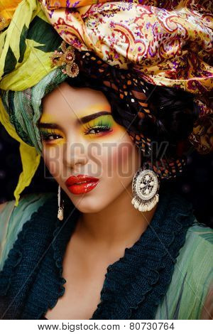 beauty bright woman with creative make up, many shawls on head l