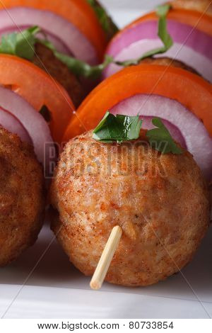 Fried Meatballs On Skewers With Vegetables Macro. Vertical