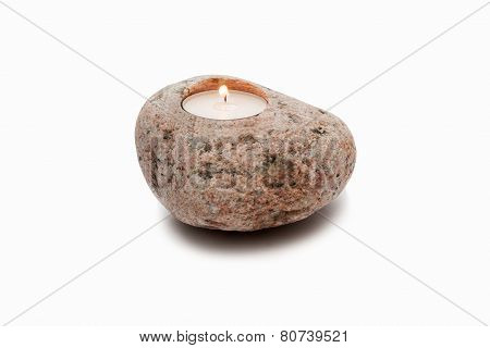 Candle in stone on a white background