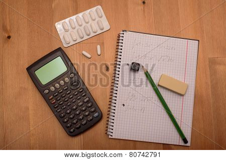 Study Place With Calculator And Painkillers In Background