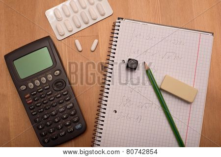 Study Place With Calculator And Painkillers In Background