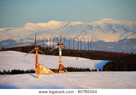 Abandonned wind turbines in winter landscape - sunset light