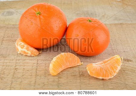 Mandarines With Pieces Isolated On Wooden Table