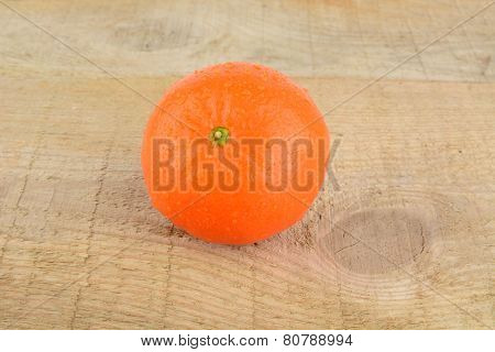 Studio Shot Wet Tangerine Isolated On Wooden Table