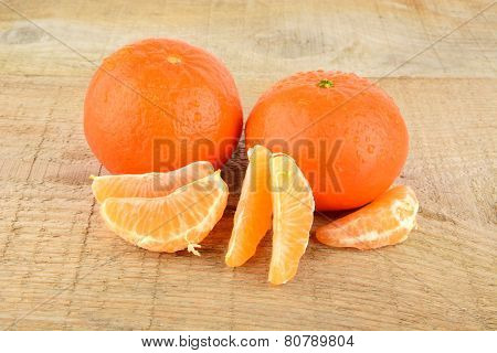 Mandarines With Pieces Isolated On Wooden Table