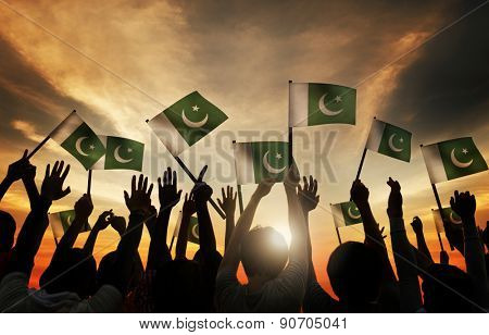 Group of People Waving Flag of Pakistan in Back Lit