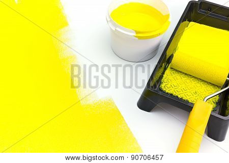 Can Of Yellow Paint With Paint Roller And Tray