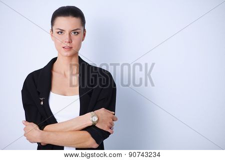 A young woman standing, isolated on graybackground