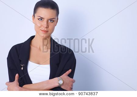 A young woman standing, isolated on graybackground