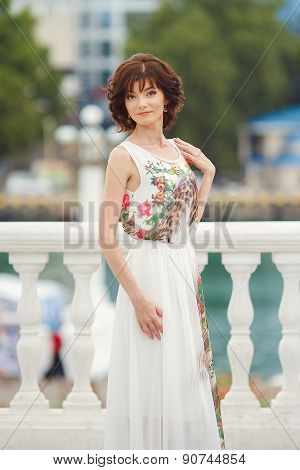 Closeup portrait of a beautiful woman in the city at summer time