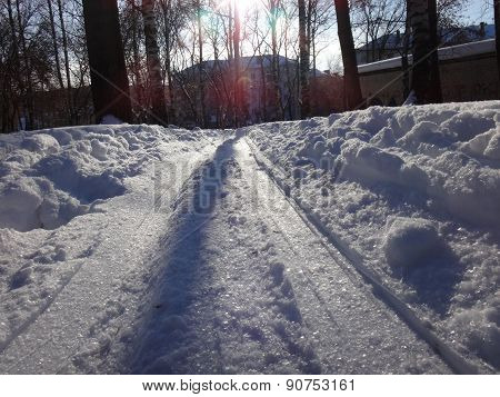 Winter road in the park wiht snow