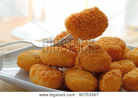 chicken nuggets served in a white bowl