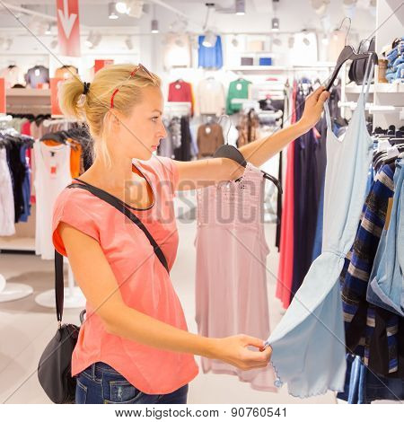 Beautiful woman shopping in clothing store.