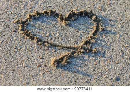heart shape drawn in the sand