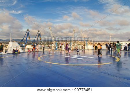 Tourists In Helipad For Helicopter On The Upper Deck Of Big Cruise Ship