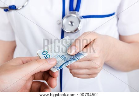 Patient Bribing Doctor, Giving Money To The Hand